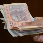 Rupee Slips By 2 Paise To Close at 77.57 Against US Dollar